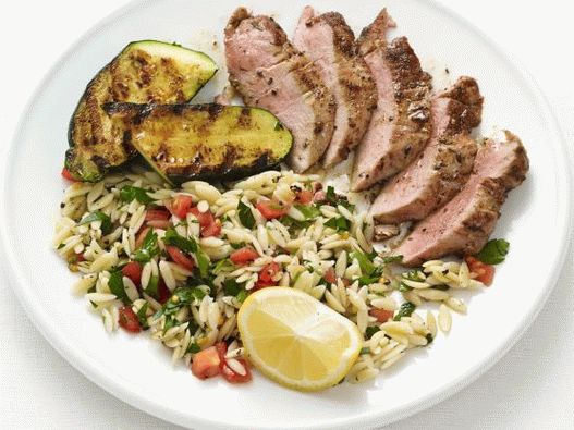 Photo Fried pork chops and zucchini with orzo